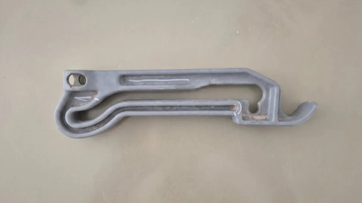 The original worn tractor side-mirror arm as it came in - grey, long out of production